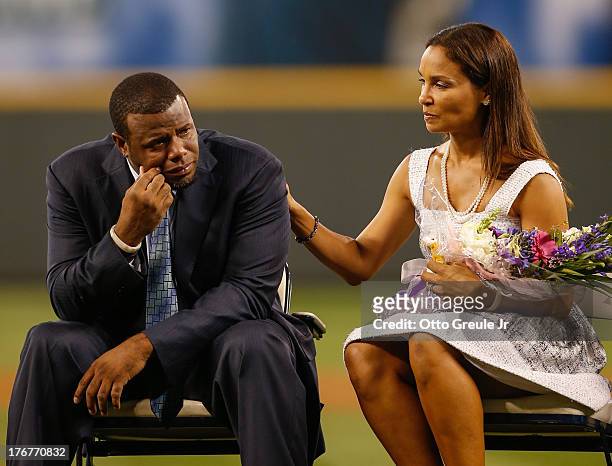 Former Mariners great, Ken Griffey Jr. Is comforted by his wife Melissa after he teared up following a video greeting from his son Trey during a...