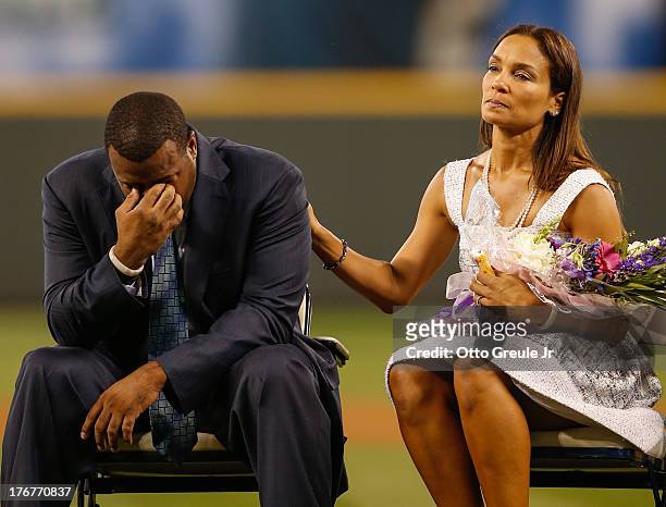 Former Mariners great, Ken Griffey Jr. Is comforted by his wife Melissa after he teared up following a video greeting from his son Trey during a...