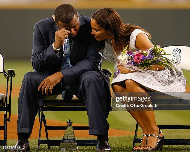 Former Mariners great, Ken Griffey Jr. Is comforted by his wife Melissa after he teared up following a video greeting from his son Trey during a...