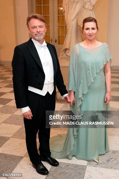 Denmark's Prime Minister Mette Frederiksen and husband Bo Tengberg arrive for a State Banquet at Christiansborg Castle in Copenhagen on November 6 on...