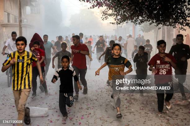 Palestinian children run as they flee from Israeli bombardment in Rafah in the southern Gaza Strip on November 6 amid continuing battles between...