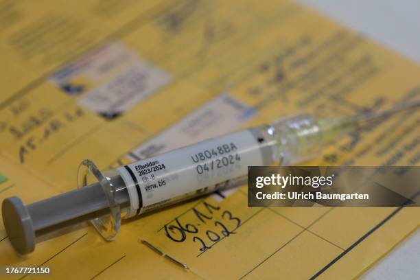 In this photo illustration a syringe with the flu vaccine Eflueld is seen with a vaccination certificate on November 06, 2023 in Bonn, Germany. The...