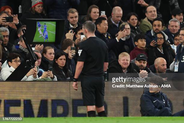 Referee Michael Oliver checks the VAR screen during the Premier League match between Tottenham Hotspur and Chelsea FC at Tottenham Hotspur Stadium on...