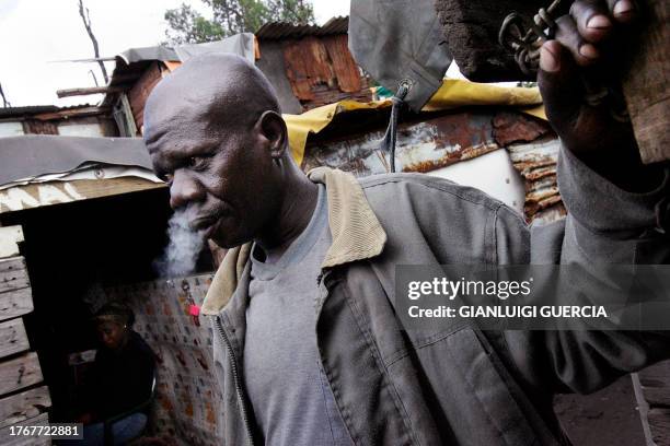 South African resident of one of Durban Central' slums smokes, 21 december 2005. From the slums of Durban, a new movement is giving voice to millions...