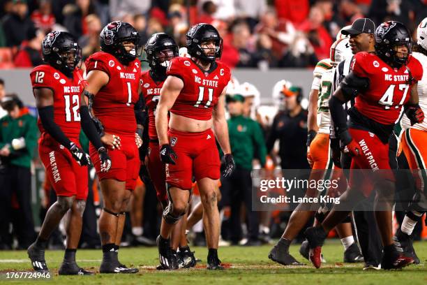 Davin Vann and Payton Wilson of the NC State Wolfpack look on against the Miami Hurricanes at Carter-Finley Stadium on November 4, 2023 in Raleigh,...