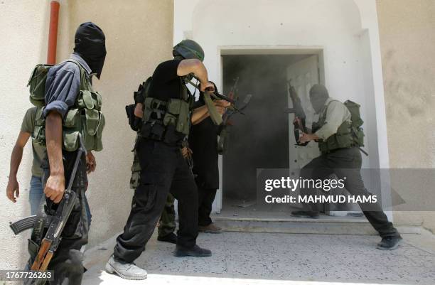 Smoke is seen as Hamas militants break down a door inside the pro-Fatah Preventative Security compound after taking over the headquarters following...