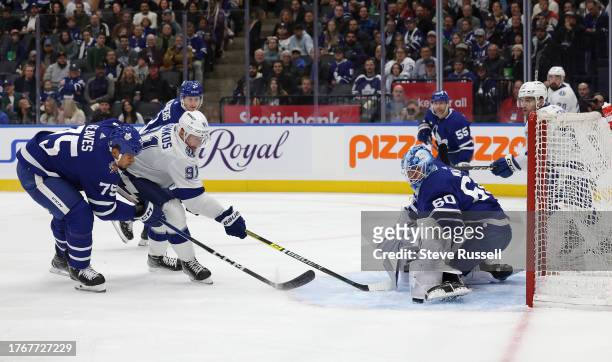 Toronto Maple Leafs goaltender Joseph Woll stops Tampa Bay Lightning center Steven Stamkos as Toronto Maple Leafs right wing Ryan Reaves chases in...