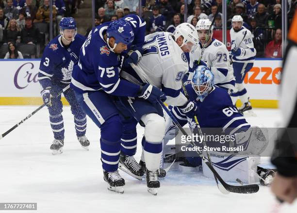 Toronto Maple Leafs goaltender Joseph Woll stops Tampa Bay Lightning center Steven Stamkos as Toronto Maple Leafs right wing Ryan Reaves chases in...