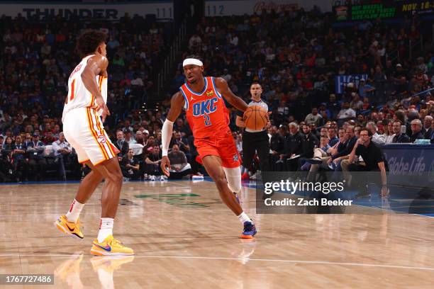 Shai Gilgeous-Alexander of the Oklahoma City Thunder dribbles the ball during the game against the Atlanta Hawks on November 6, 2023 at Paycom Arena...