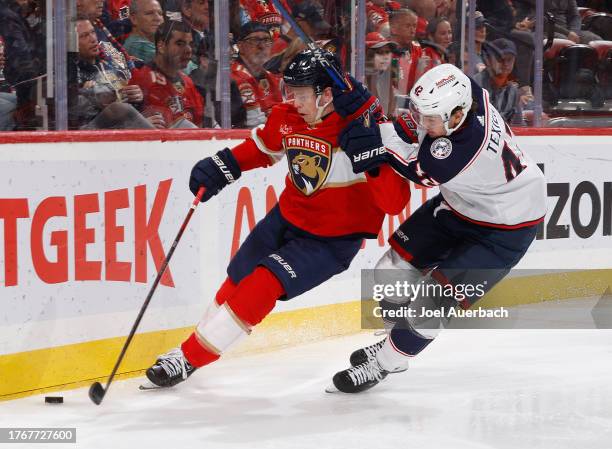 Alexandre Texier of the Columbus Blue Jackets attempts to take the puck from Mike Reilly of the Florida Panthers during second period action at the...