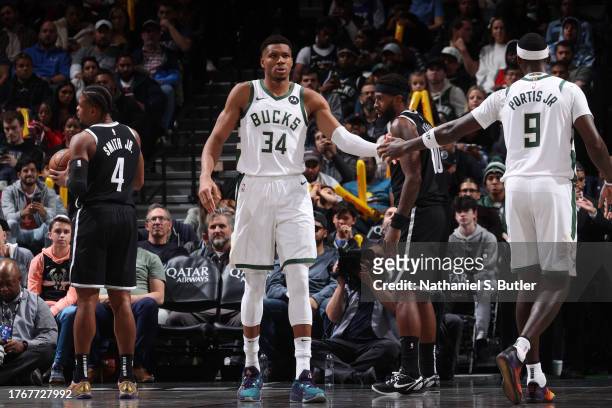 Giannis Antetokounmpo high fives Bobby Portis of the Milwaukee Bucks during the game against the Brooklyn Nets on November 6, 2023 at Barclays Center...