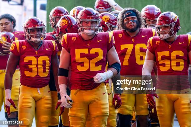 Trojans offensive lineman Jarrett Kingston , center, stands with teammates before running onto the field before the game against Washington at L.A....
