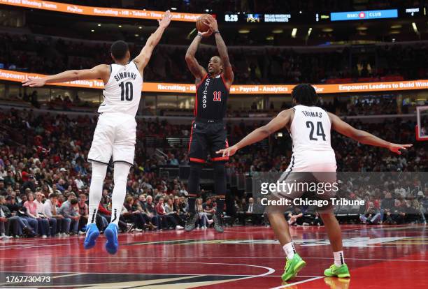 Chicago Bulls forward DeMar DeRozan shoots as Brooklyn Nets guard Ben Simmons defends in the third quarter at the United Center on Nov. 3 in Chicago.