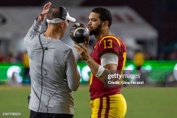 Trojans head coach Lincoln Riley talks with USC Trojans quarterback Caleb Williams during the team's 52-42 loss to Washington at L.A. Memorial...