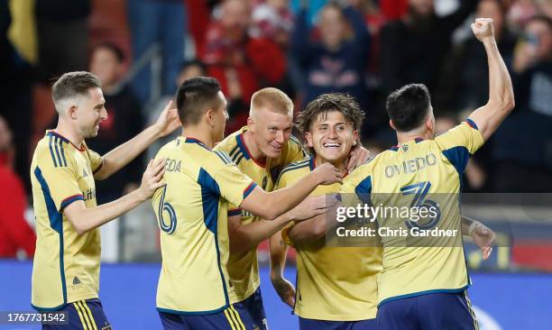 Diego Luna of Real Salt Lake is congratulated by teammates Bryan Oviedo, Justen Glad, Braian Ojeda, and Andrew Brody after making the final penalty...