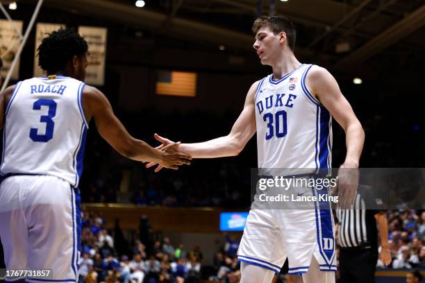 Kyle Filipowski high-fives Jeremy Roach of the Duke Blue Devils during the second half of the game against the Dartmouth Big Green at Cameron Indoor...