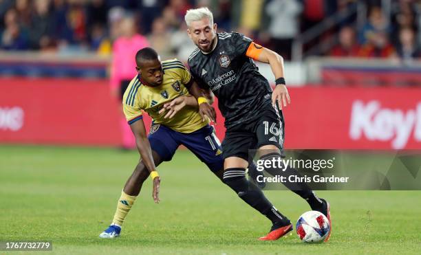 Hector Herrera of the Houston Dynamo takes the ball past Carlos Gomez of Real Salt Lake during the second half of their MLS Cup Western conference...