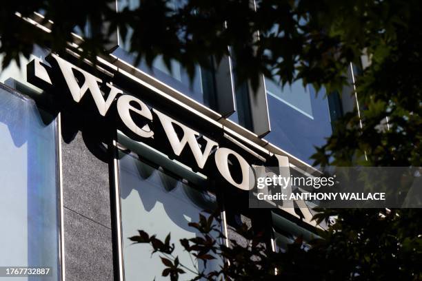 Signage for shared office giant WeWork is seen outside a building in Seoul on November 7, 2023. Beleaguered shared office giant WeWork, which has...