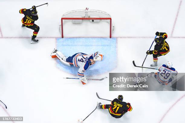 Nils Hoglander of the Vancouver Canucks scores a goal on Stuart Skinner of the Edmonton Oilers during the second period of their NHL game at Rogers...