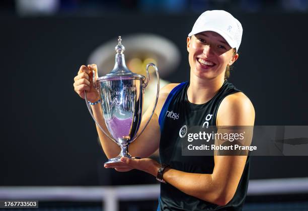Iga Swiatek of Poland poses with the champions trophy after defeating Jessica Pegula of the United States in the final of the GNP Seguros WTA Finals...