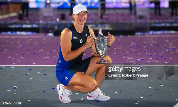 Iga Swiatek of Poland poses with the champions trophy after defeating Jessica Pegula of the United States in the final of the GNP Seguros WTA Finals...