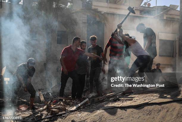 People search for victims following an Israeli airstrike on a house in Khan Yunis in the southern Gaza Strip, on November 6, 2023.