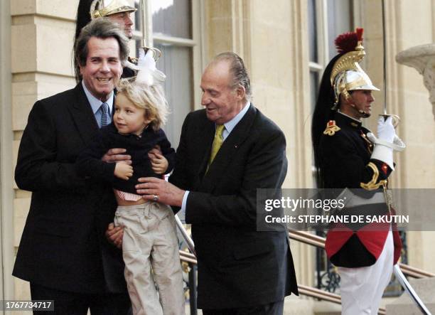 King Juan Carlos of Spain is greeted by French Lower Assembly speaker Jean-Louis Debre with his grandson Camille before meeting for talks at the...