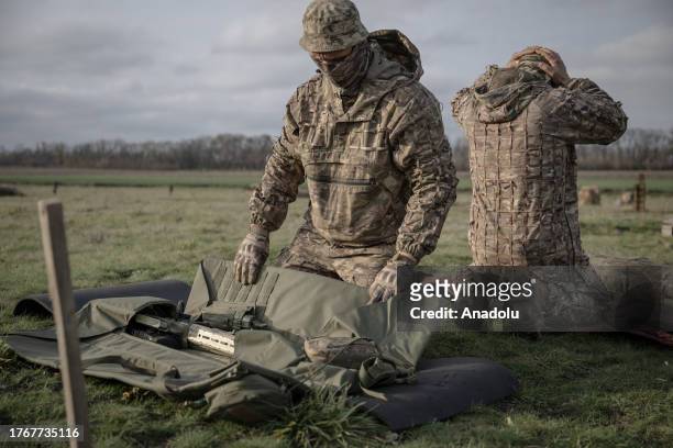 Snipers from the 108th Territorial Defense Brigade of the Ukrainian Army are seen during military training, including camouflage, weapon handling and...