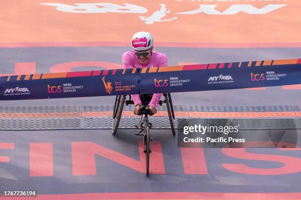 Catherine Debrunner of Switzerland crossing finish line with time 1:39:32 as a winner of TCS New York City marathon in wheelchair women's division in...