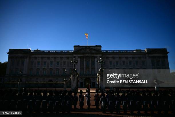 Members of the Welsh Guards, a unit of the Household Division Foot Guards, form an Honour Guard outside of Buckingham Palace in London on November 7,...