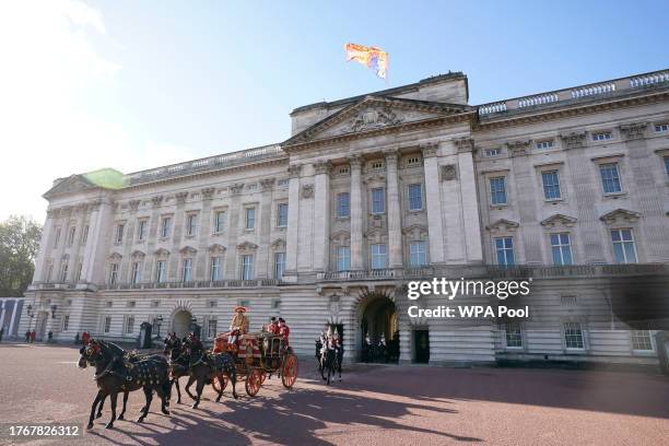 The Royal Standard flies as the horses and coach carrying the Imperial State Crown leaves Buckingham Palace ahead of the State Opening of Parliament...