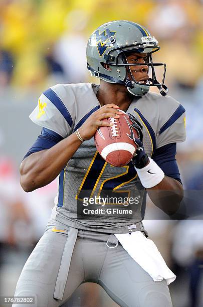 Geno Smith of the West Virginia Mountaineers drops back to pass against the Maryland Terrapins on September 22, 2012 at Mountaineer Field in...