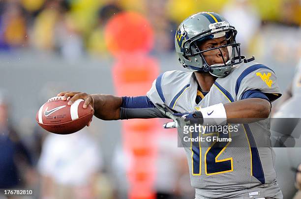 Geno Smith of the West Virginia Mountaineers throws a pass against the Maryland Terrapins on September 22, 2012 at Mountaineer Field in Morgantown,...