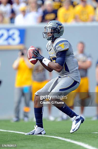 Geno Smith of the West Virginia Mountaineers drops back to pass against the Maryland Terrapins on September 22, 2012 at Mountaineer Field in...