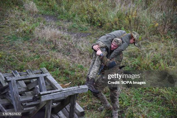 Participants of the military training for the civilian population learn to provide first aid in case of injury and practice the evacuation of the...