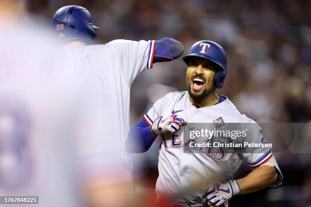 Marcus Semien of the Texas Rangers celebrates after hitting a home run in the third inning against the Arizona Diamondbacks during Game Four of the...