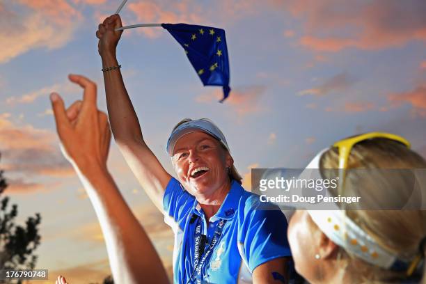 Captain Liselotte Neumann of Sweden and the European Team is hoisted onto the shoulders of her players after defeating the United States Team and...