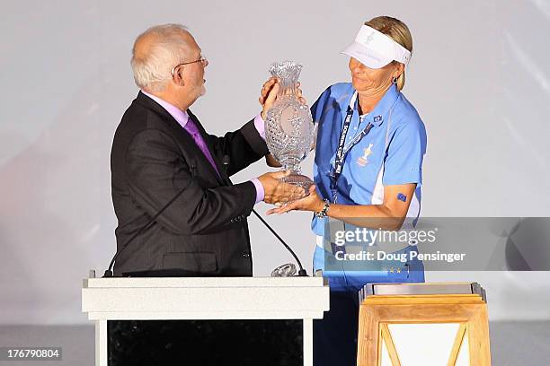 John Solheim, CEO of Ping, presents the Solheim Cup to captain Liselotte Neumann of the European Team after they defeated the United States Team...