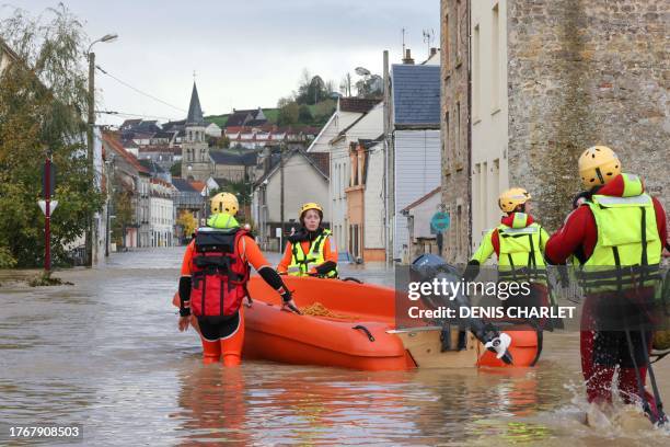 French Firefighters walk in a flooded street during a rescue operation in Isques, near Boulogne-sur-Mer, northern France on November 7, 2023. Dozens...