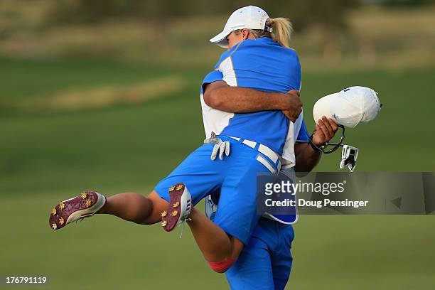 Jodi Ewart-Shadoff of England and the European Team is lifted by her caddie Myles Blackwelder on the 16th hole as she defeated Brittany Lincicome of...