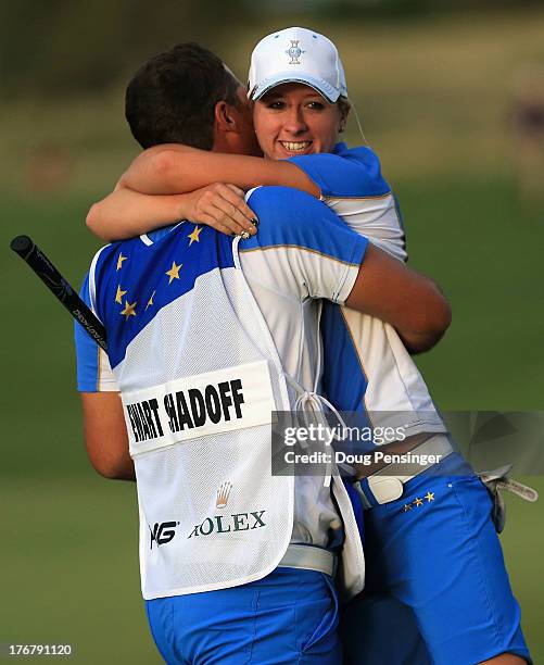 Jodi Ewart-Shadoff of England and the European Team is lifted by her caddie Myles Blackwelder on the 16th hole as she defeated Brittany Lincicome of...