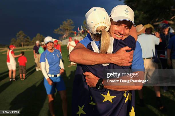 Jodi Ewart-Shadoff of England and the European Team celebrates with Azahara Munoz's caddie Tim Vickers after Ewart-Shadoff defeated Brittany...