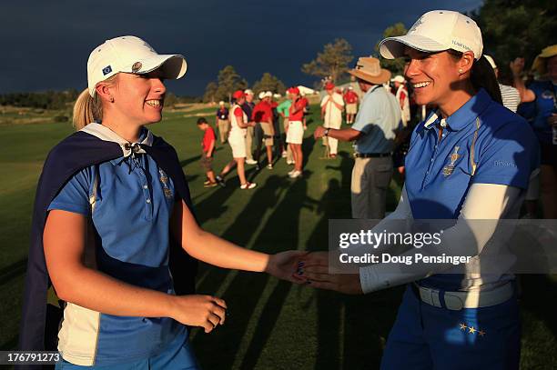 Jodi Ewart-Shadoff of England and the European Team celebrates with Azahara Munoz of Spain and the European Team after Ewart-Shadoff defeated...