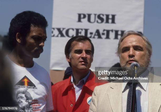 April 21: Reverend Jesse Jackson, California governor Jerry Brown and actor Marlon Brando on stage at Dodger Stadium for an event to raise money...