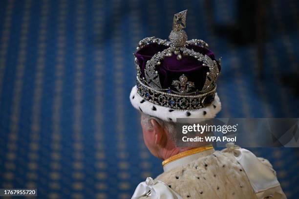 King Charles III, wearing the Imperial State Crown and the Robe of State, processes through the Royal Gallery during the State Opening of Parliament...