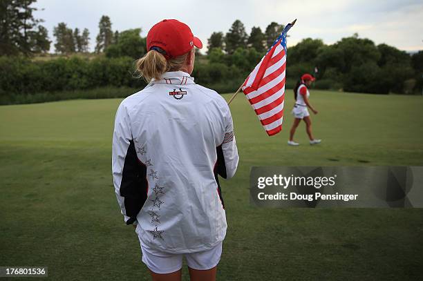 Morgan Pressel of the United States Team stands with a flag as teammate Gerina Piller plays the 17th hole during the final day singles matches of the...