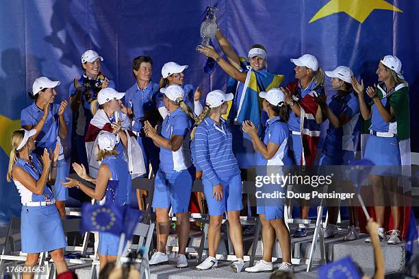 Anna Nordqvist of Sweden and the European Team hoists the Solheim Cup during closing ceremonies for the 2013 Solheim Cup on August 18, 2013 at the...