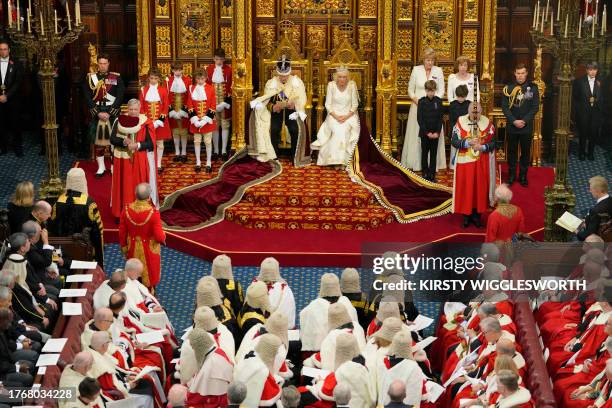 Britain's King Charles III, wearing the Imperial State Crown and the Robe of State, and Britain's Queen Camilla, wearing the George IV State Diadem,...