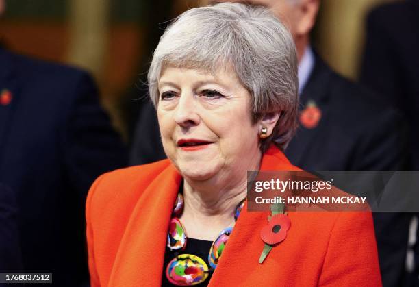 Britain's former prime minister Theresa May walks through the House of Commons Members' Lobby during the State Opening of Parliament at the Houses of...