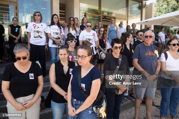 People stand in a moment of silence to commemorate victims of the October 7 attacks on November 7, 2023 in Tel Aviv, Israel. A month after Hamas's...